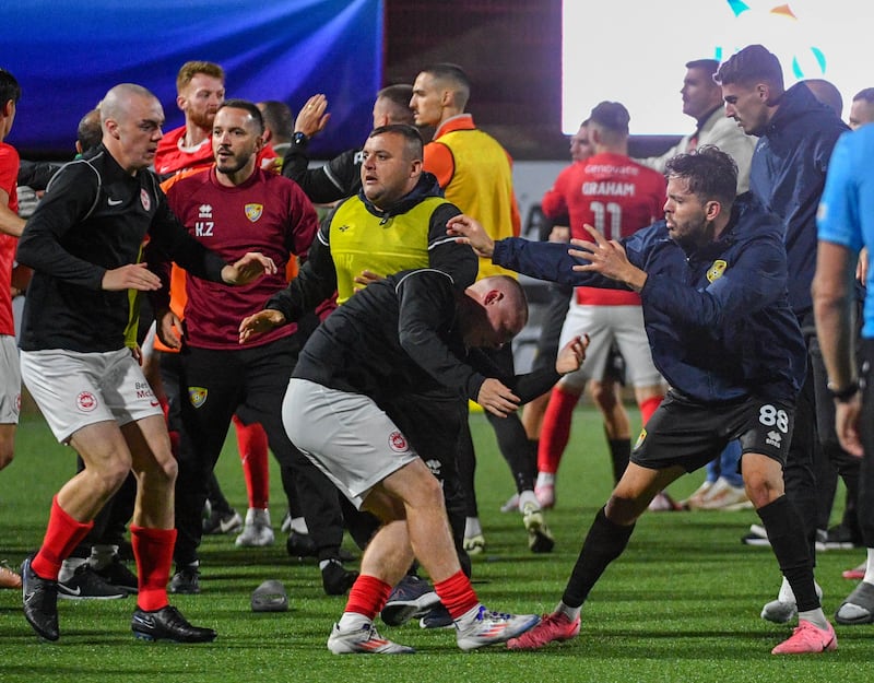 Football players fighting on a football pitch