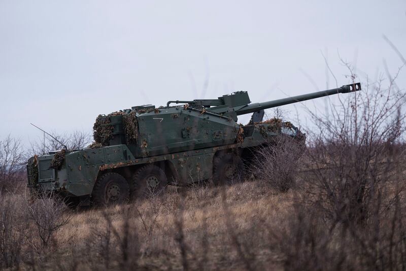 A Ukrainian self-propelled howitzer Dita of the Azov brigade rides to firing position on the frontline (Evgeniy Maloletka/AP)