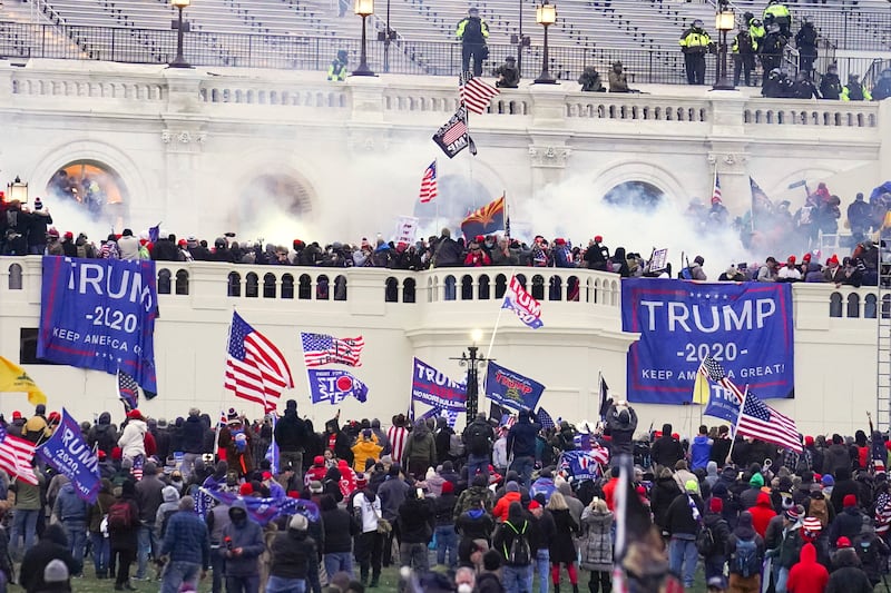 Rioters attempt to storm the US Capitol building on January 6 2021 (John Minchillo/AP)