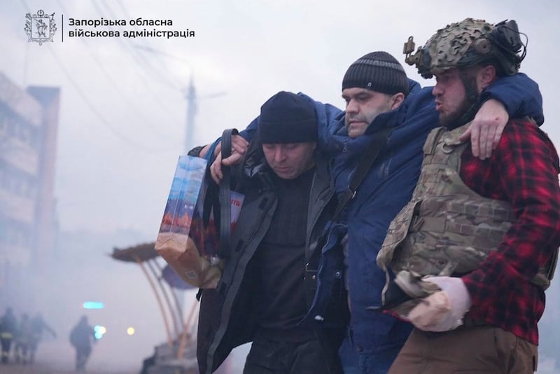 Paramedics carry an injured man into an ambulance (Zaporizhzhia regional military administration via AP)