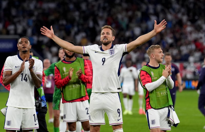 England captain Harry Kane celebrates with fans after the 2-1 win over Slovakia