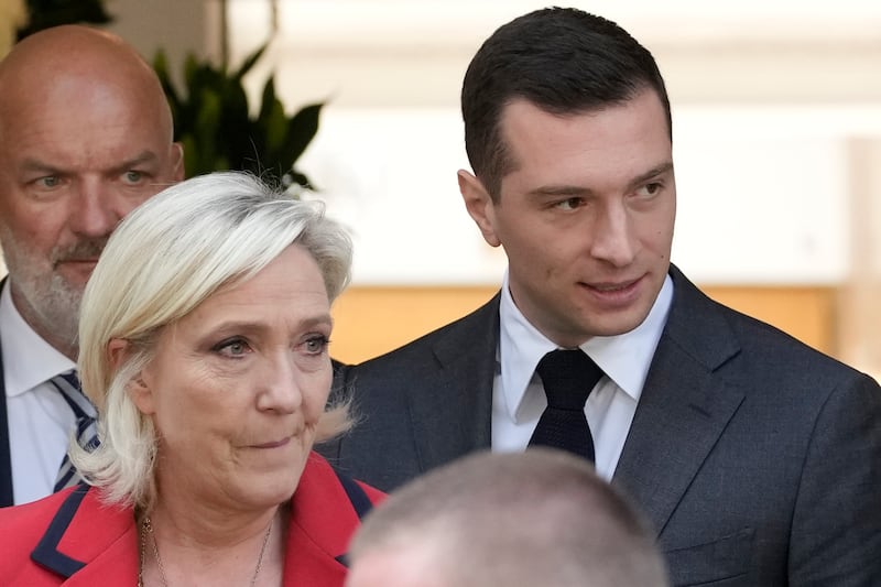 Far-right National Rally party president Jordan Bardella, right, leaves with far-right leader Marine Le Pen after a press conference (AP)