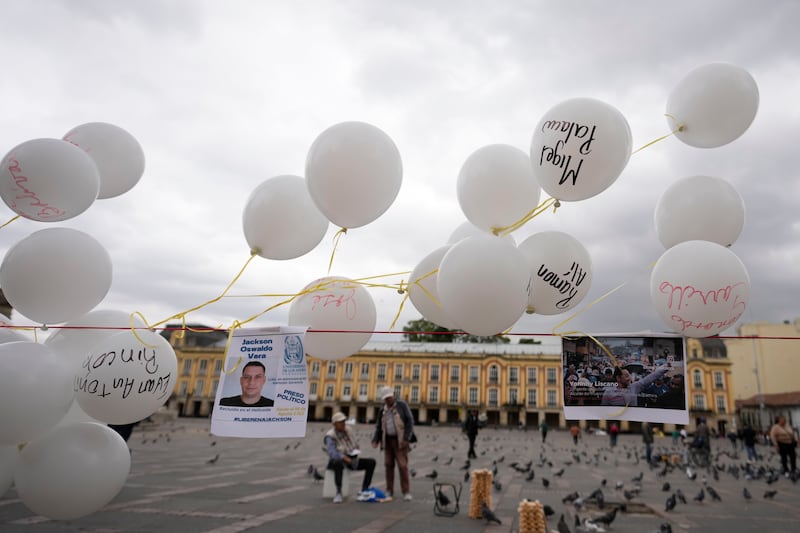 Photos and balloons representing people detained by Venezuelan security forces after Venezuela’s presidential election at Bolivar square in Bogota, Colombia (Fernando Vergara/AP)