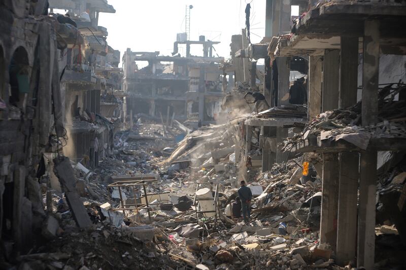 Palestinians inspect their homes destroyed by Israeli attacks in Jabaliya, northern Gaza Strip (Jehad Alshrafi/AP)