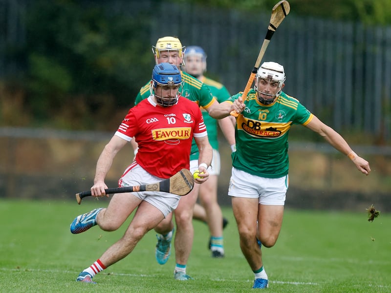 Dunloy's Seaan Elliott closes in on Loughgiel's Dan Mccloskey during Sunday's county semi-final in Cushendall. Picture by John McIlwaine