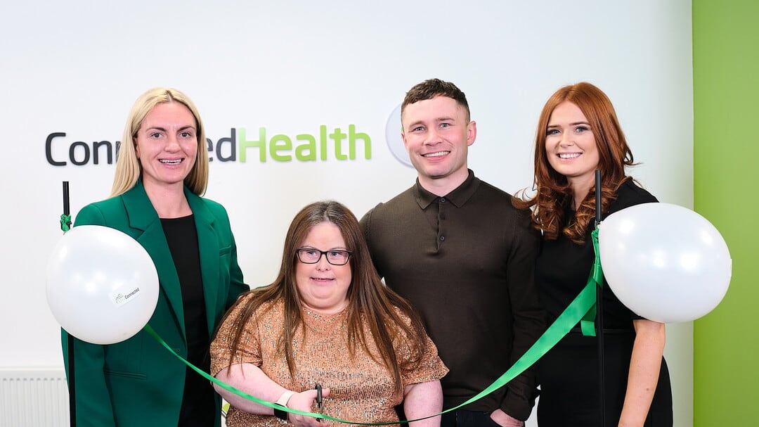 Callain Sturgeon cuts the ribbon to launch the new Live Connected service with (L-R): Theresa Morrison, Connected Health; Carl Frampton, and Shauna Doyle, operations manager, Live Connected.