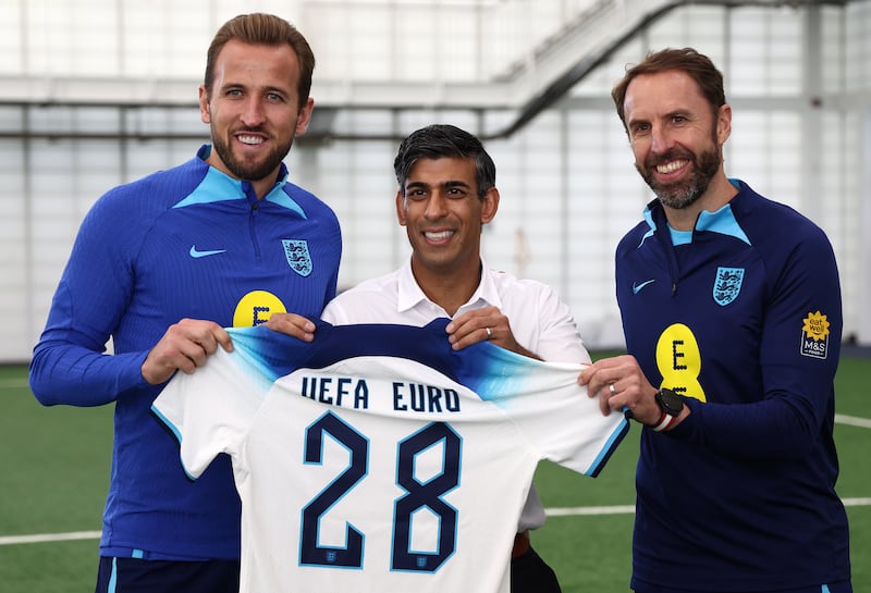 Rishi Sunak with Harry Kane and Gareth Southgate during a visit to St George’s Park, in Burton upon Trent, Staffordshire