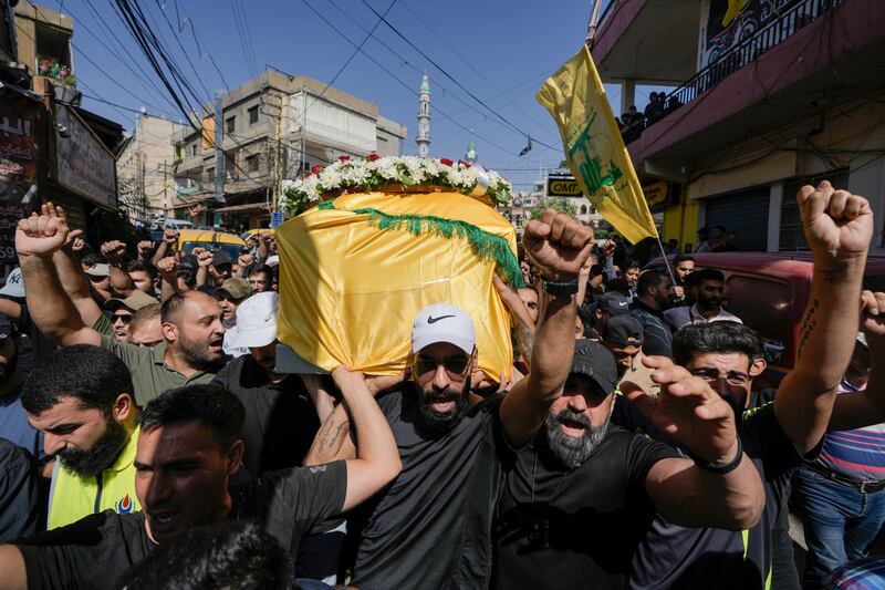 Mourners chant slogans as they carry the coffin of Ali Ahmad Mousawi, who was killed early Wednesday by an Israeli strike, during his funeral procession in Nabi Sheet village, in Lebanon’s eastern Bekaa Valley, (Bilal Hussein/AP)