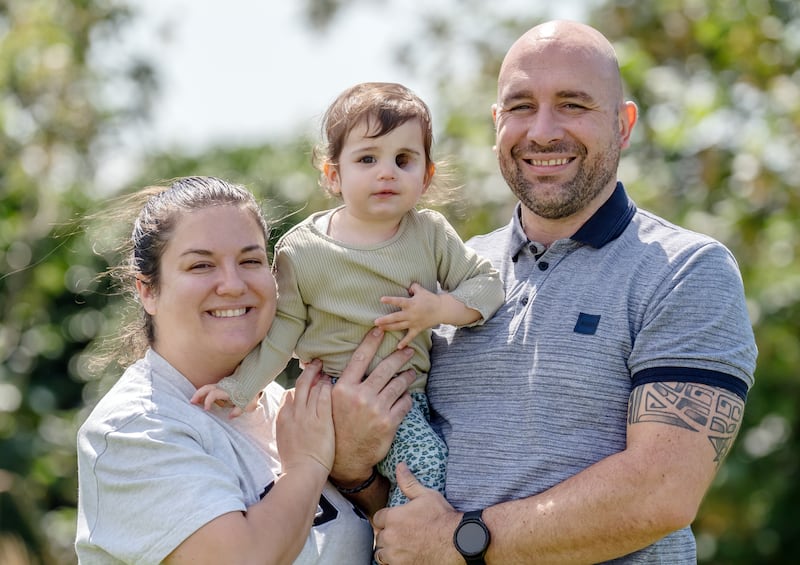 EMBARGOED TO 0001 THURSDAY JULY 25Nuala Mulholland, a 19-month-old who was diagnosed with a rare soft tissue tumour when she was just 10 months old that meant she needed her eye removed, with her parents Megan and Richard Mulholland. In a pioneering treatment, clinicians at Alder Hey Children’s Hospital have designed prosthetic eye for Nuala, she had her first fitting for in June this year. Picture date: Thursday July 25, 2024. PA Photo. See PA story HEALTH Eye . Photo credit should read: Danny Lawson/PA Wire