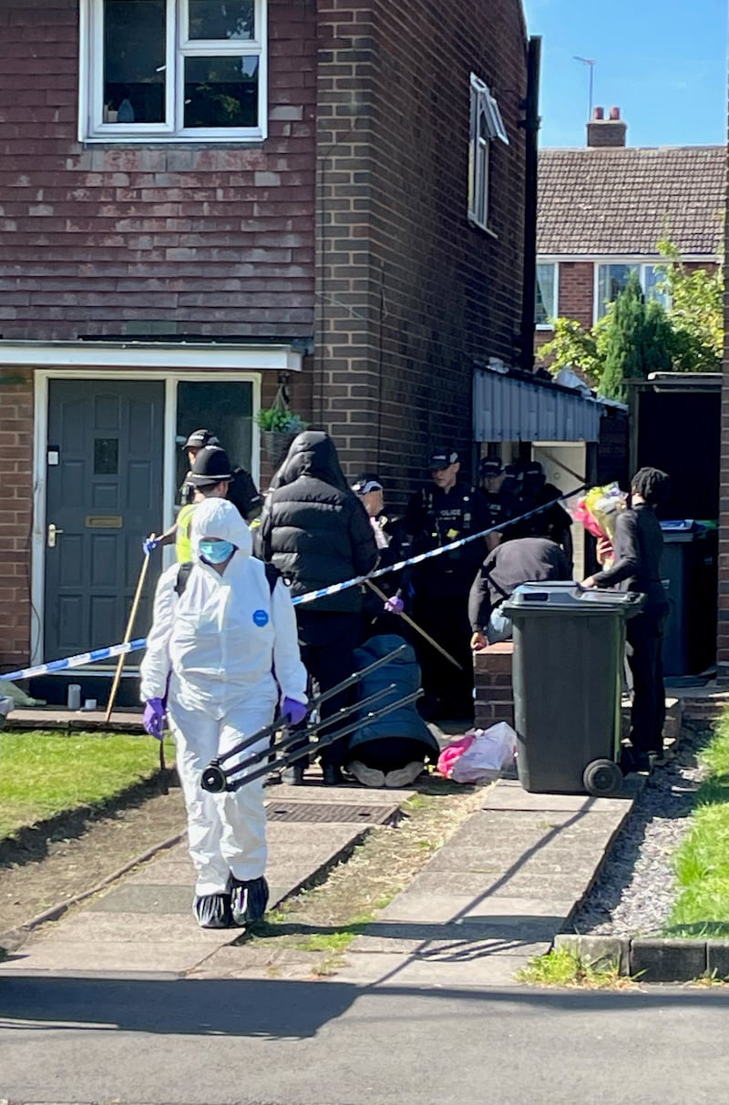 Forensics officers and police at the scene in Lovett Avenue, Oldbury, on Friday