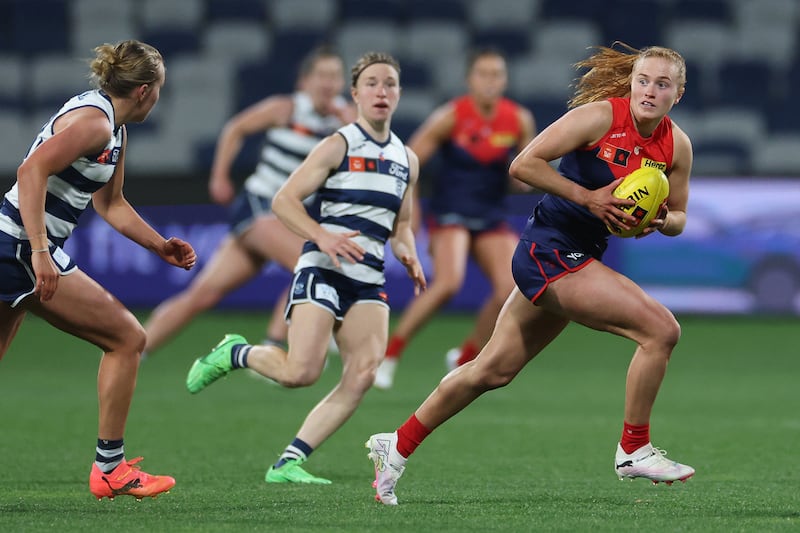 GEELONG, AUSTRALIA - AUGUST 31: Blaithin Mackin of the Demons runs with the ball under pressure from Zali Friswell of the Cats during the round one AFLW match between Geelong Cats and Melbourne Demons at GMHBA Stadium, on August 31, 2024, in Geelong, Australia. (Photo by Daniel Pockett/Getty Images)