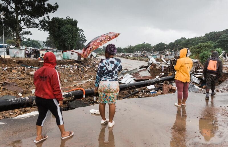 Women on the road to the bridge over the Palmiet River survey the flood damage. The bridge was blocked with debris so the water was unable to flow under it. Infrastructure can sometimes increase risk and is often destroyed by floods. Picture by Rajesh Jantilal