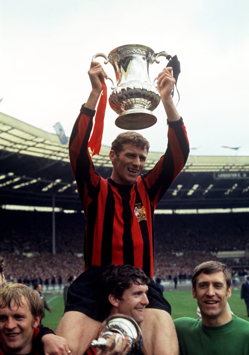 Tony Book is carried on Mike Doyle’s shoulders as Manchester City celebrate FA Cup success in 1969 .