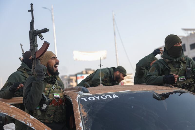 Syrian opposition fighters ride along the streets in the aftermath of the opposition’s takeover of Hama (Ghaith Alsayed/AP)