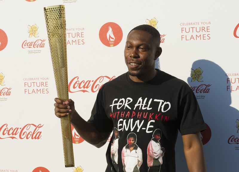 Dizzee Rascal holding an Olympic Torch in Hyde Park, central London.