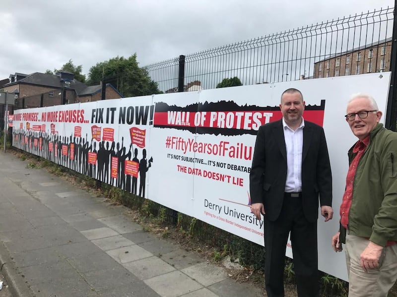 Derry University Group members, Kevin Hippsley (left)  and Conal McFeely spoke at the unveiling of a 55 ft "Wall of Protest" at Craigavon Bridge in the city.