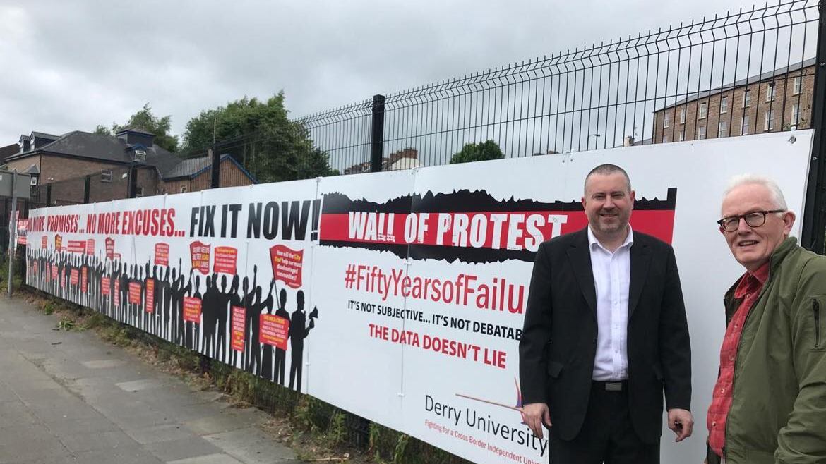 Derry University Group members, Kevin Hippsley (left)  and Conal McFeely spoke at the unveiling of a 55 ft "Wall of Protest" at Craigavon Bridge in the city.