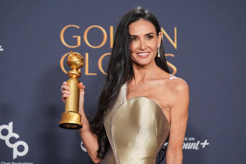 Demi Moore poses with her Golden Globe award on Sunday (Chris Pizzello/AP)