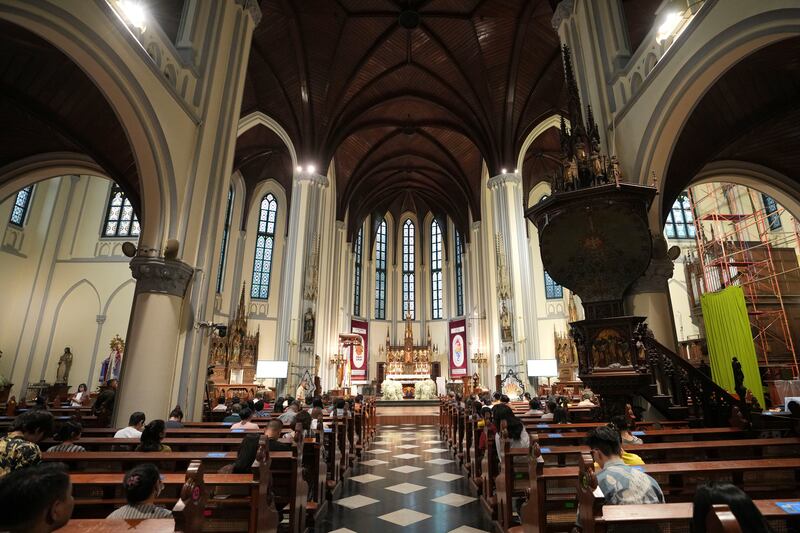 People attend an evening mass at The Church of Our Lady of the Assumption, popularly known as the Jakarta Cathedral, in Jakarta (Achmad Ibrahim/AP)