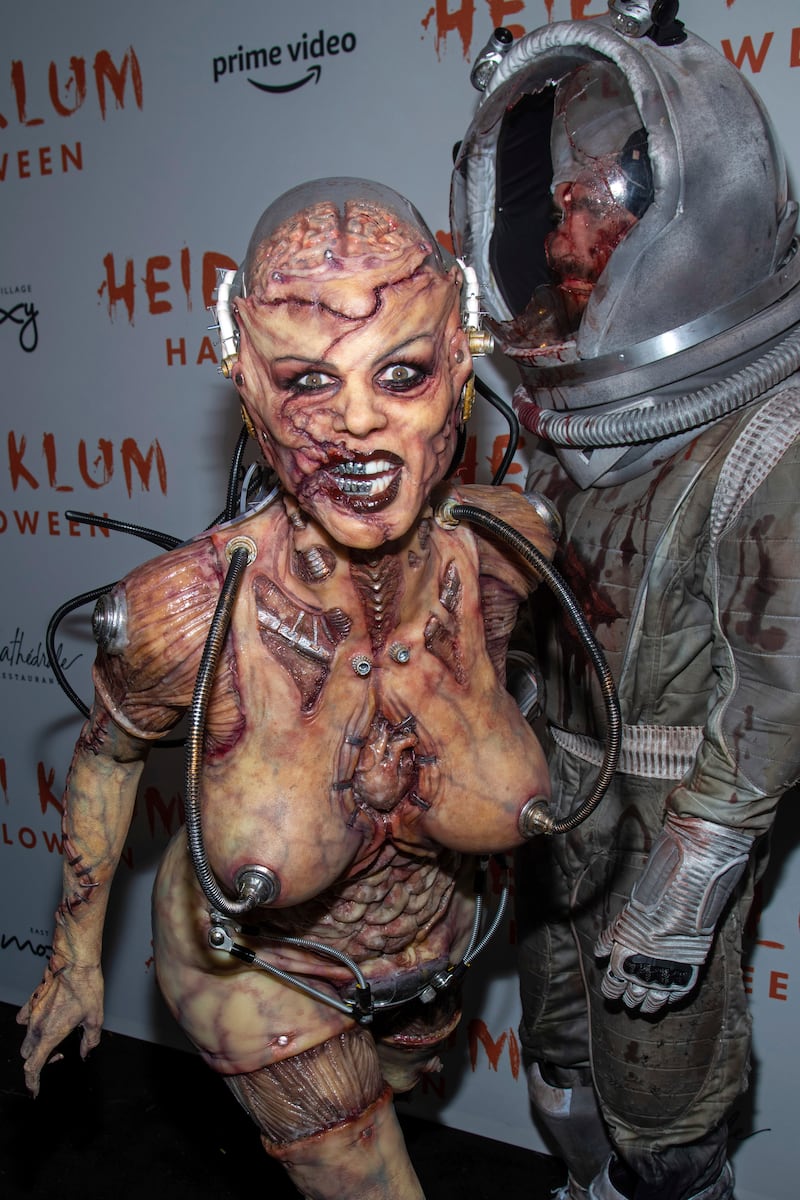 Heidi Klum, left, dressed as an alien, and Tom Kaulitz attend her Halloween party in 2019 (Charles Sykes/Invision/AP)