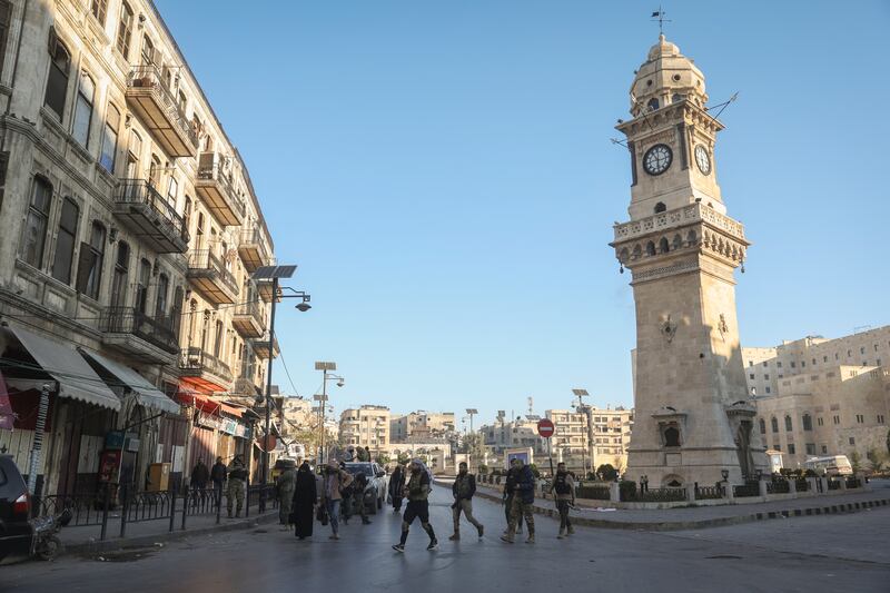 Syrian opposition fighters patrol the streets of Aleppo (Ghaith Alsayed/AP)