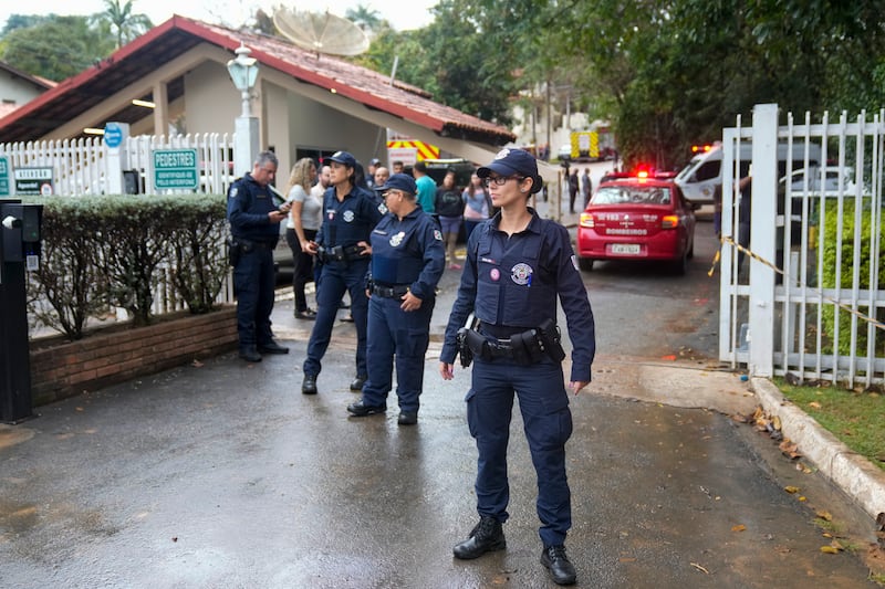 Police guard the gated community where a plane crashed in Vinhedo, Sao Paulo state, Brazil (Andre Penner/AP)