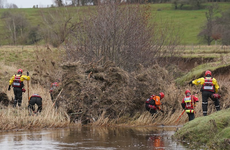 Members of a search and rescue team search through river debris during the operation at Abberwick Ford on the River Aln near Alnwick, Northumberland