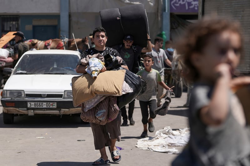 Palestinians evacuate a school in eastern Deir al-Balah, Gaza Strip (Abdel Kareem Hana/AP)