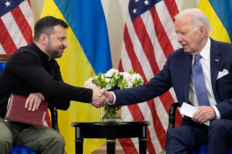 US President Joe Biden shakes hands with Ukrainian President Volodymyr Zelensky (Evan Vucci/AP)