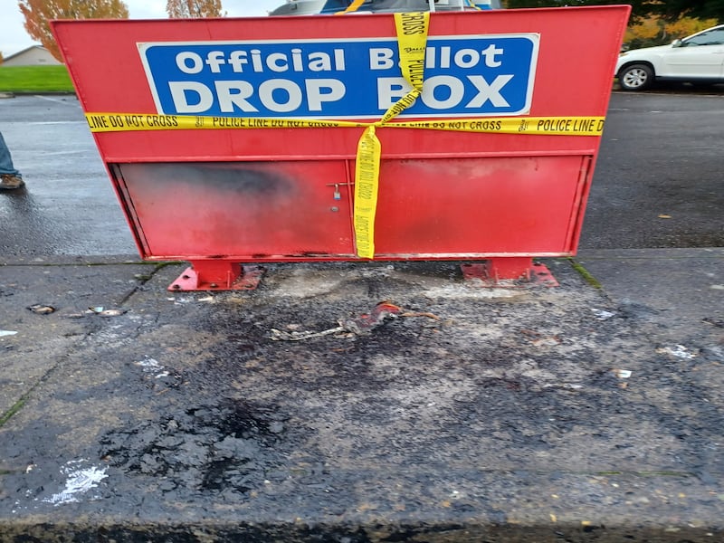 Police tape surrounds a ballot drop box damaged by a fire in Vancouver, Washington (Monika Spykerman/The Columbian/AP)