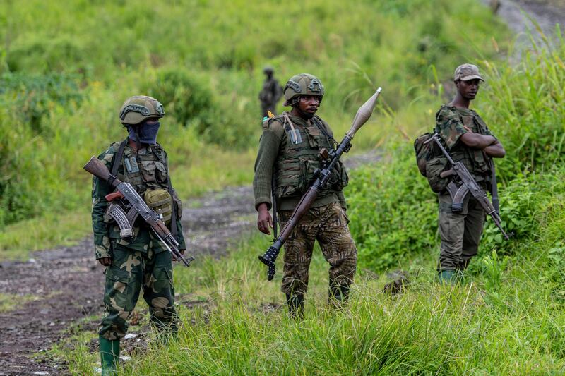 FILE – M23 rebels stand with their weapons in Kibumba, in eastern DR Congo in 2022. (Moses Sawasawa, File/AP)