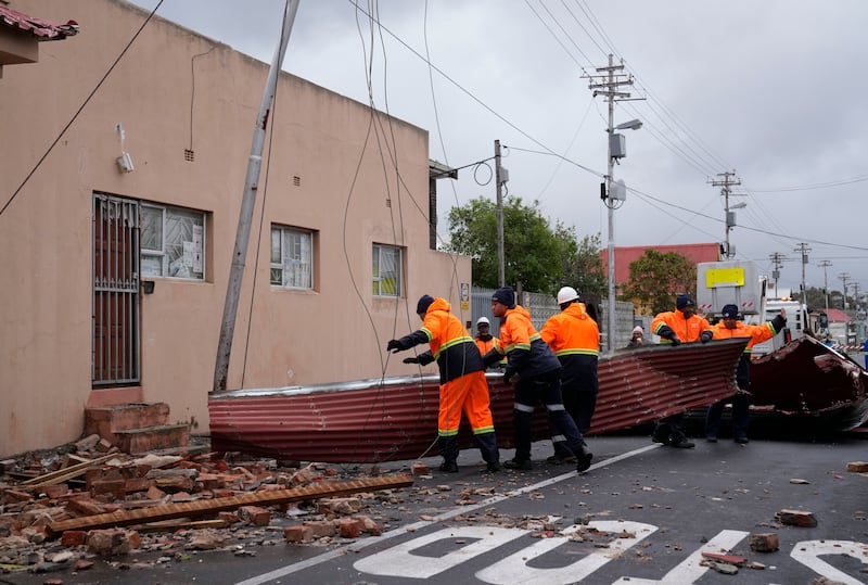 Strong winds blew off roofs, destroyed parts of houses and other buildings, and brought down electricity poles (Nardus Engelbrecht/AP)
