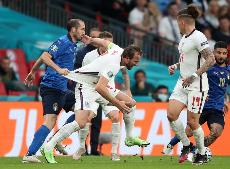 Giorgio Chiellini (left) pulls back Harry Kane during the Euro 2020 final at Wembley