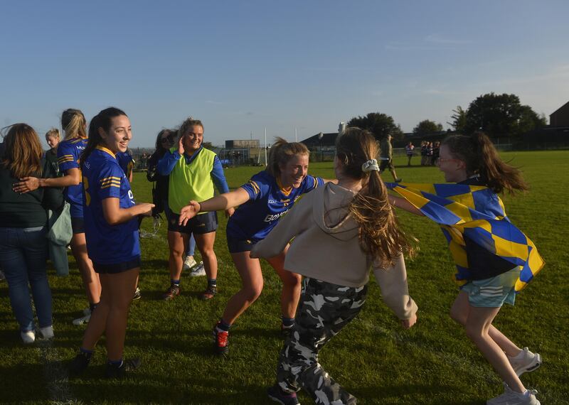 Moneyglass captain Cathy Carey celebrates with young fans following her side's win over St Paul's the Antrim Senior Ladies' Football Championship final at Davitt Park on Sunday    Picture: Mark Marlow