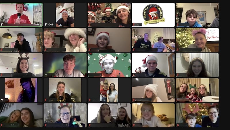 Harry wearing a Santa hat on a video screen, alongside other people who dialled in to the virtual Christmas party