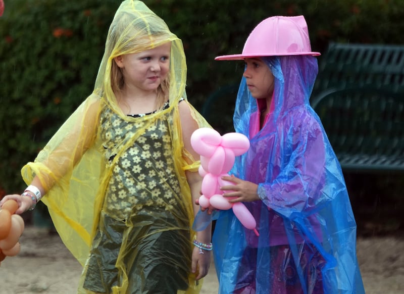 Chloe Fleming, left, and Maya Teixiera don’t let the rain from approaching Tropical Storm Milton dampen the day during Oktoberfest in Oakland Park, Florida (Joe Cavaretta/South Florida Sun-Sentinel/AP)