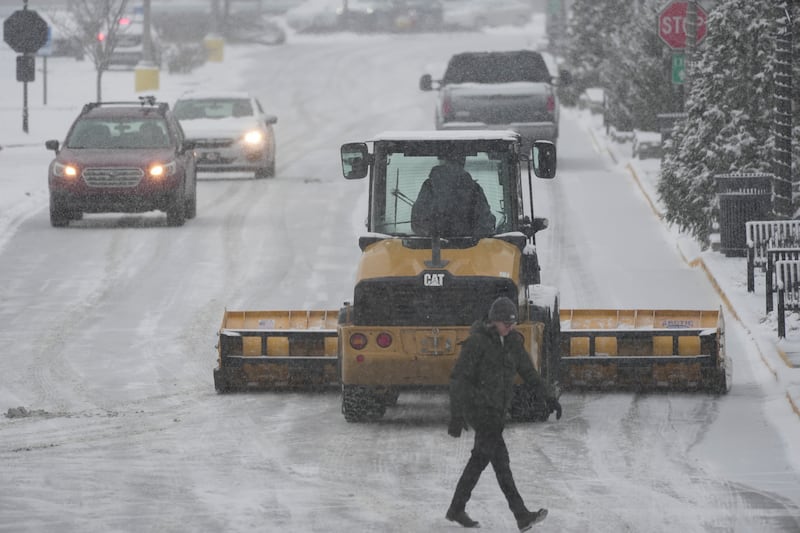 A plough clears a car park in Cincinnati (Joshua A Bickel/AP)