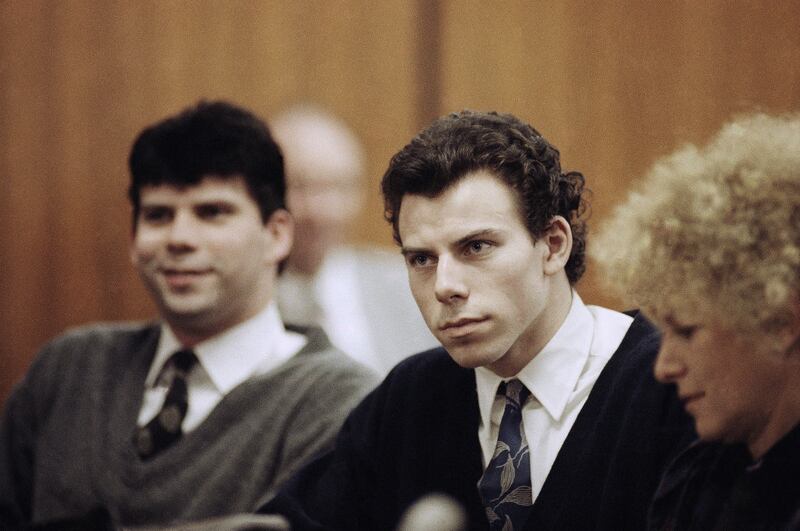 Lyle, left, and Erik Menendez sit with defence lawyer Leslie Abramson, right, during their trial in 1990 (AP Photo/Nick Ut, File)