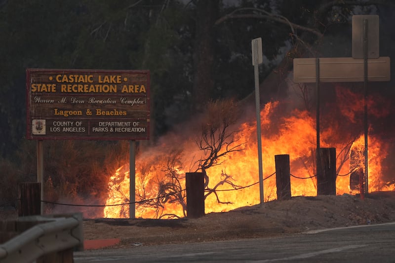 Flames caused by the Hughes Fire is seen along Castaic Lake in Castaic, Californi (Marcio Jose Sanchez/AP)