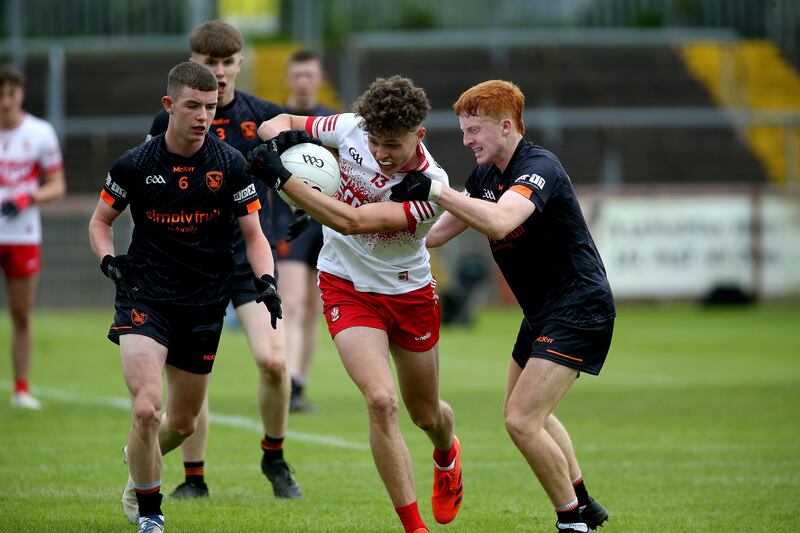 Armagh's James McCooe and Sean Woods tackle Derry's Chris McCullagh in the Ulster final. Picture: Seamus Loughran