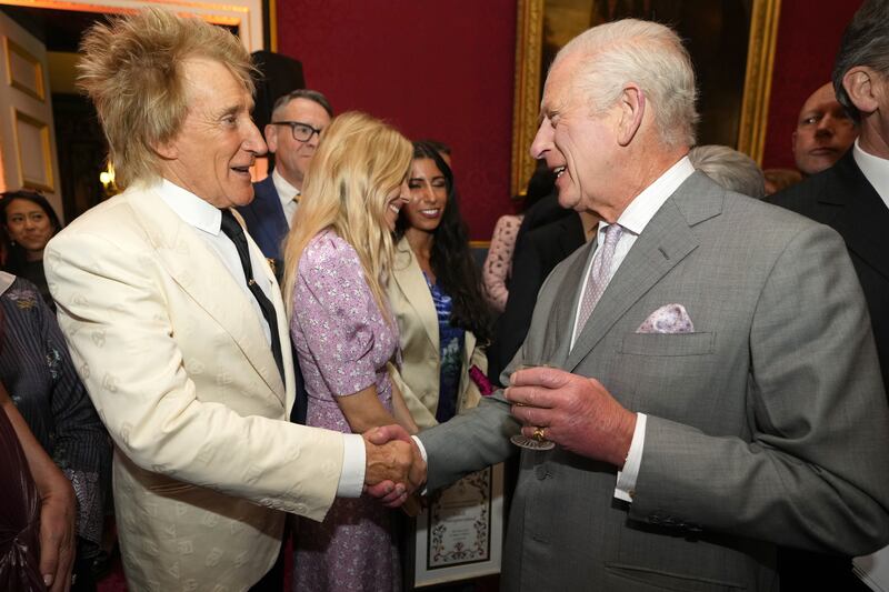 The King shakes hands with Sir Rod Stewart