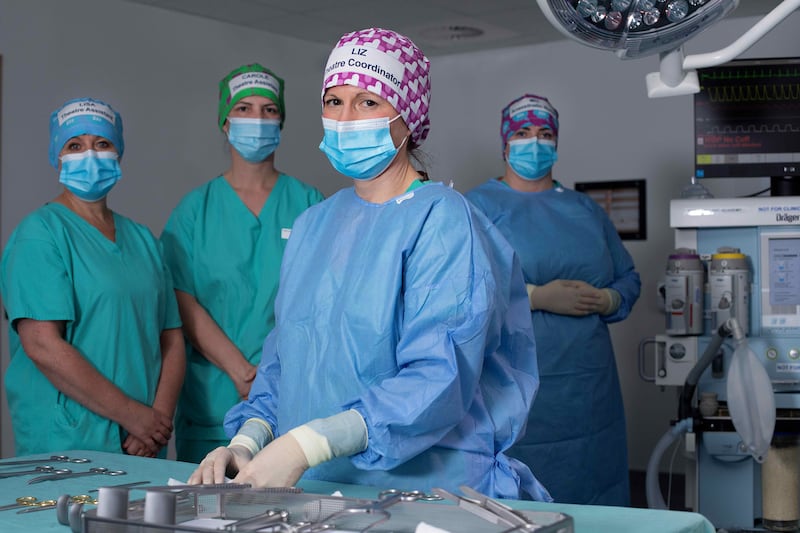 Medical staff try out the new sustainable theatre caps.