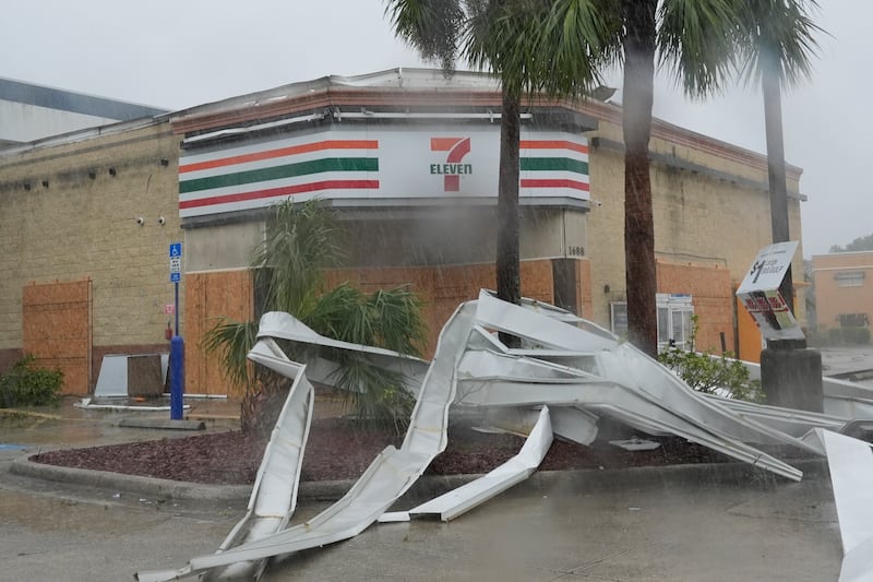 An apparent tornado caused by Hurricane Milton tore the awning off a 7-Eleven convenient store in Cape Coral (Marta Lavandier/AP)