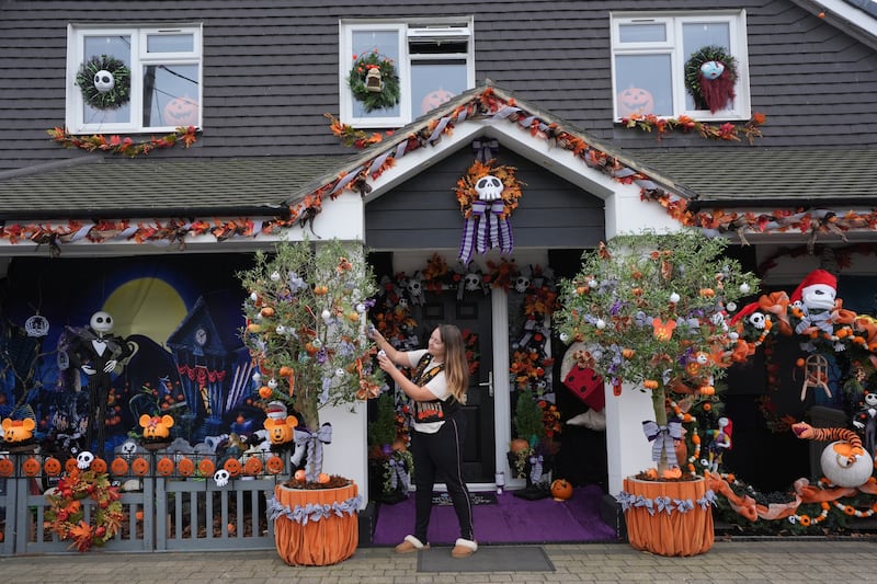 Lavinia Hedges puts the finishing touches to a Nightmare Before Christmas-themed Halloween display, which raises funds for the My Shining Star charity, at her home in Gillingham, Kent