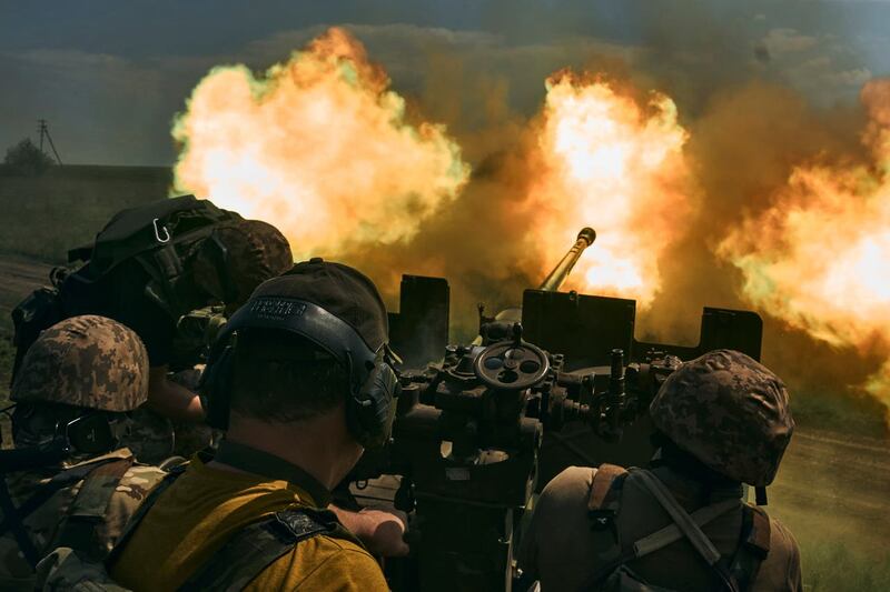 Ukrainian soldiers fire a cannon near Bakhmut