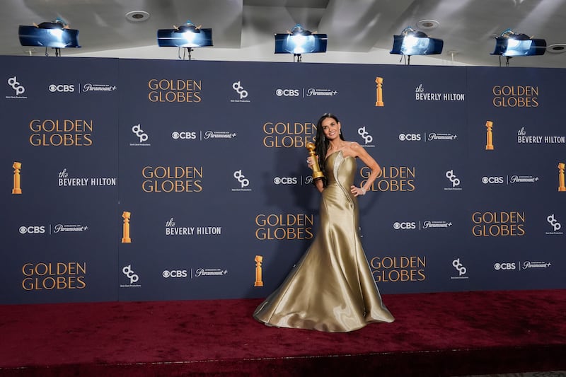 Demi Moore poses in the press room with the award for best performance by a female actor in a motion picture – musical or comedy for The Substance (Chris Pizzello/AP)