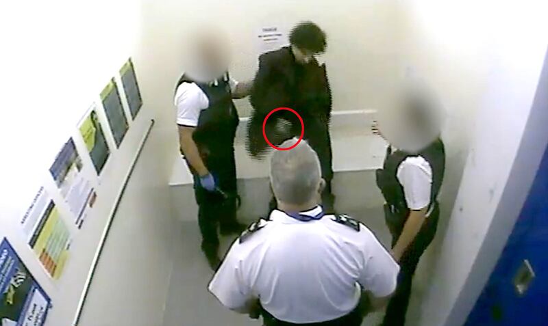 Screen grab taken from CCTV of Louis De Zoysa who is holding an item in his hand seconds before Sergeant Matt Ratana (centre) was fatally shot