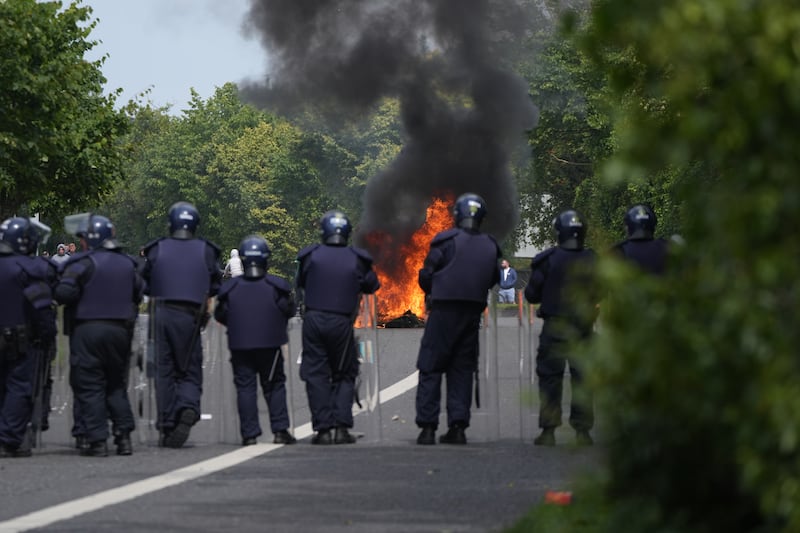 The Garda Public Order Unit as wheelie bins are set alight by protesters