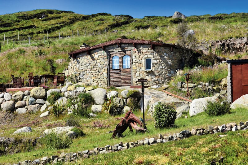 A unique little house on Arranmore, complete with a bog oak sculpture in the garden.