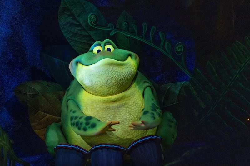 An animatronic frog playing drums on the Tiana’s Bayou Adventure attraction at Walt Disney World in Florida
